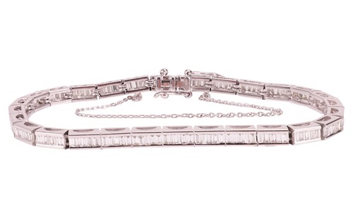 Lot 297 - A diamond-set line bracelet, the articulated...