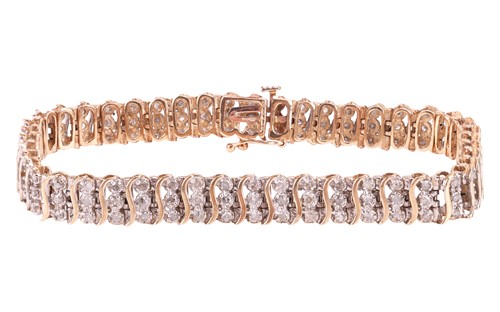Lot 105 - A diamond-set bracelet, in 9ct bi-colour gold,...