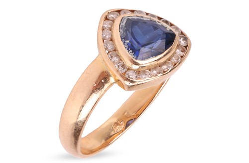 Lot 104 - A synthetic sapphire and diamond halo ring,...