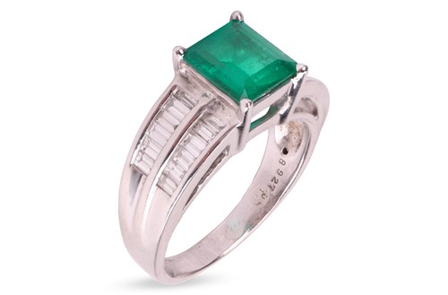 Lot 269 - An emerald and diamond dress ring, featuring a...