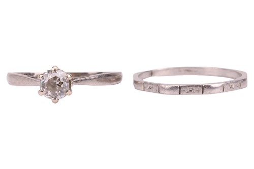 Lot 100 - A diamond solitaire ring and a wedding band;...