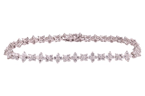 Lot 245 - A diamond-set bracelet of floral cluster form,...