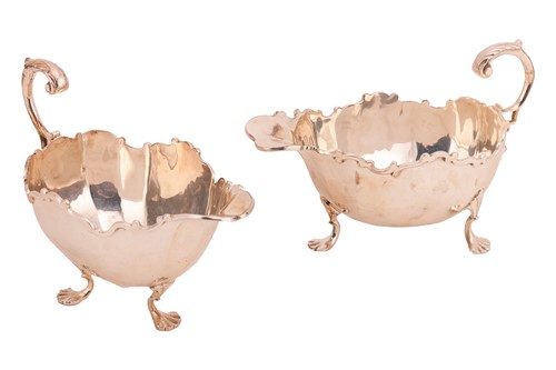 Lot 117 - A graduated matched pair of silver sauce boats,...