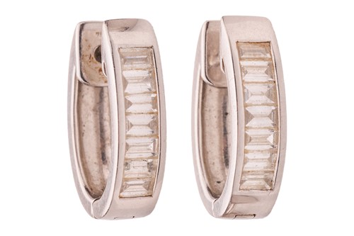 Lot A pair of diamond-set huggies earrings, each...
