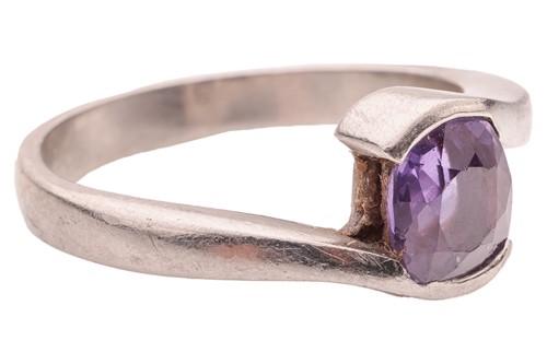 Lot A purple sapphire crossover ring, featuring a...
