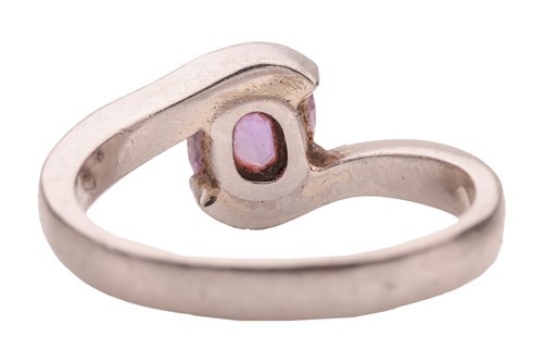Lot A purple sapphire crossover ring, featuring a...