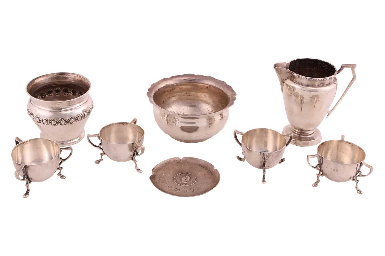 Lot 468 - A set of four silver cauldron form tyg table