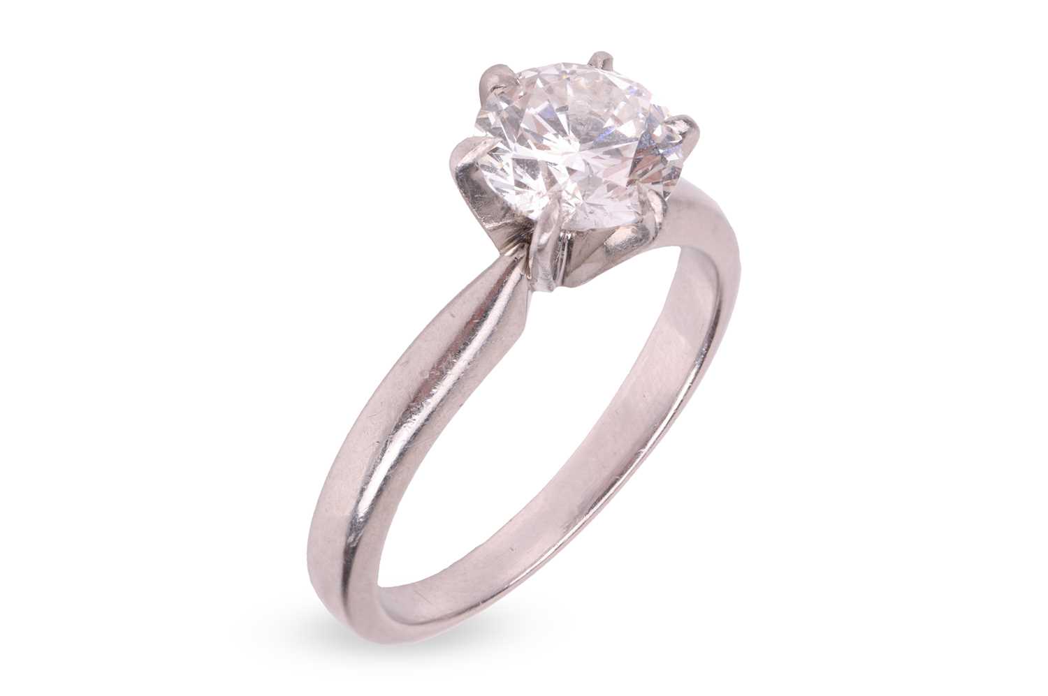 Lot A diamond solitaire ring, centred with a round...