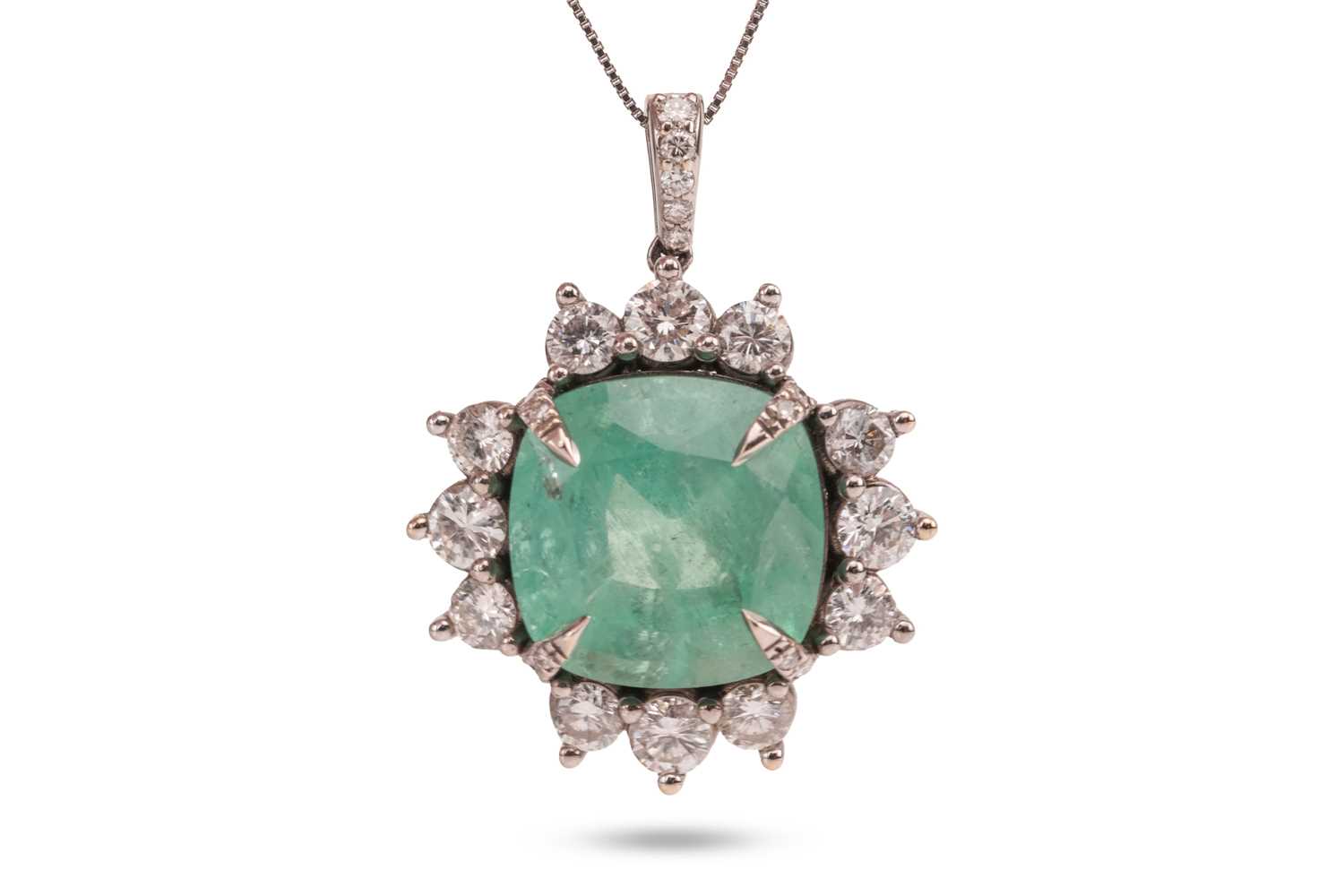 Lot An emerald and diamond pendant, comprising a...