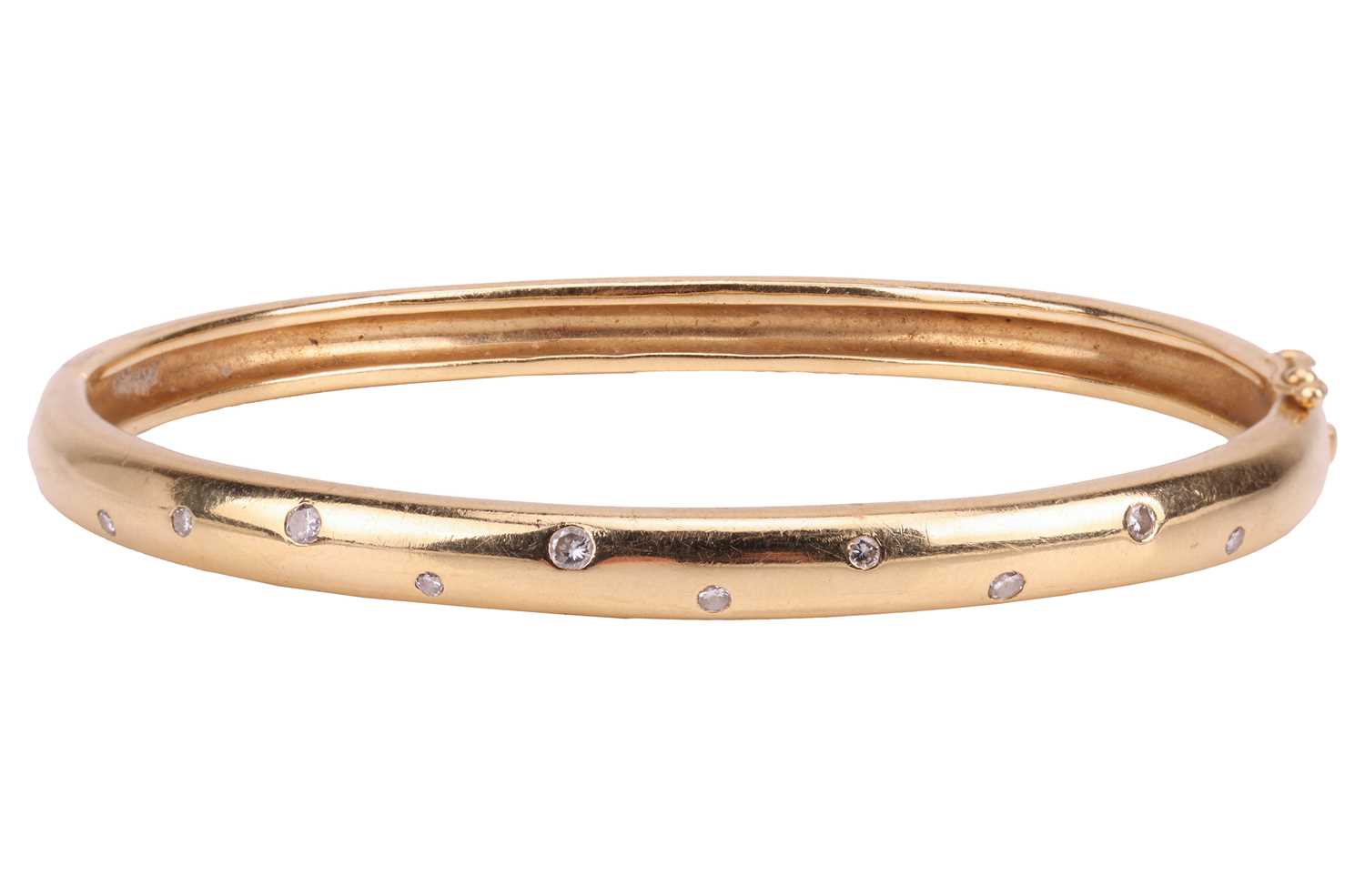 Lot 102 - A diamond-set hinged bangle, the front flush-