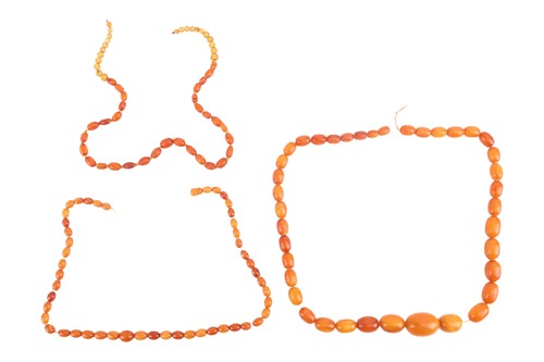 Lot 258 - Three broken amber bead necklaces; the first...