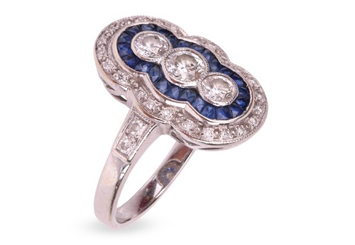 Lot A diamond and sapphire panel ring in 18ct...