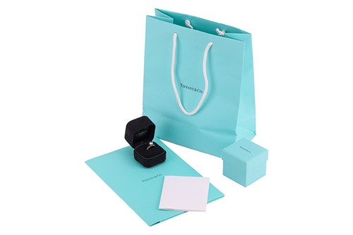 Lot 199 - Tiffany & Co. - a diamond solitaire ring, with...