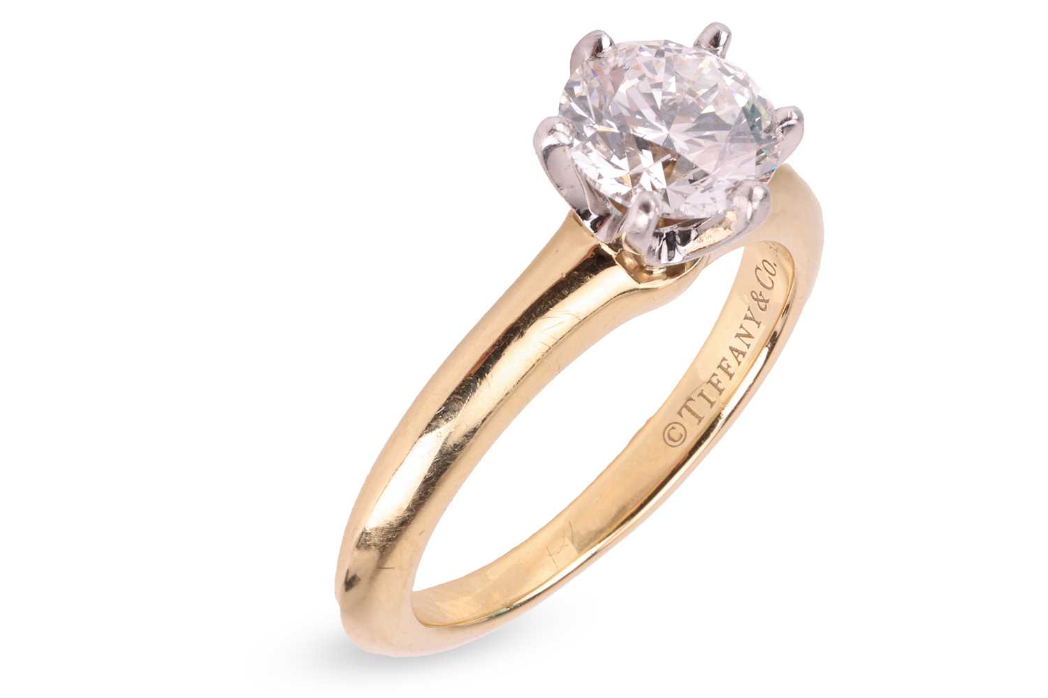 Lot 199 - Tiffany & Co. - a diamond solitaire ring, with...