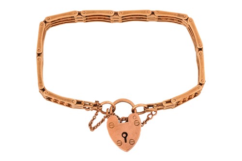 Lot 126 - A gate link bracelet, completed with a heart...