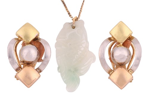 Lot 70 - A carved jade fish pendant of pale...