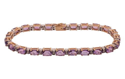 Lot 269 - An amethyst and diamond line bracelet in 9ct...