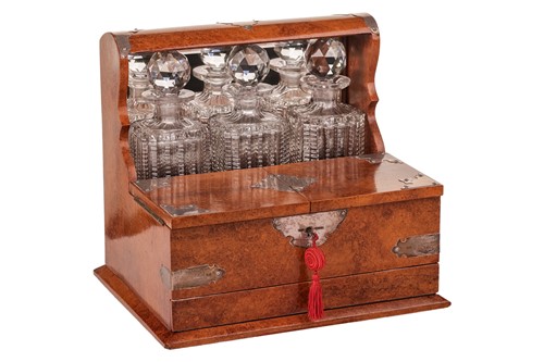 Lot 54 - A late Victorian amboyna three-bottle tantalus,...