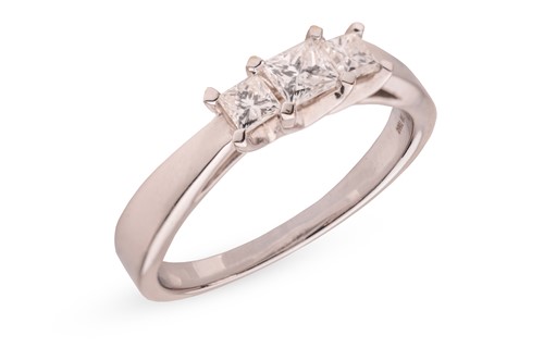 Lot 325 - A diamond trilogy ring in 18ct white gold;...