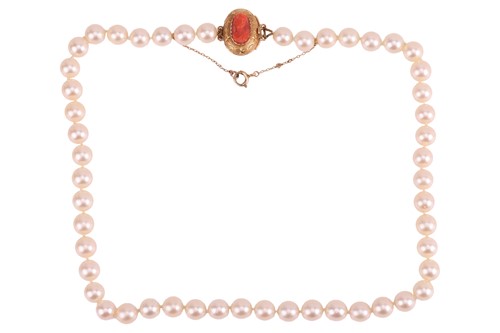 Lot 14 - A cultured pearl necklace with a coral cameo...