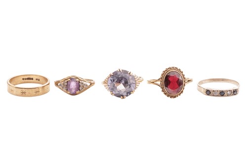 Lot 32 - Five rings; comprising a synthetic sapphire in...