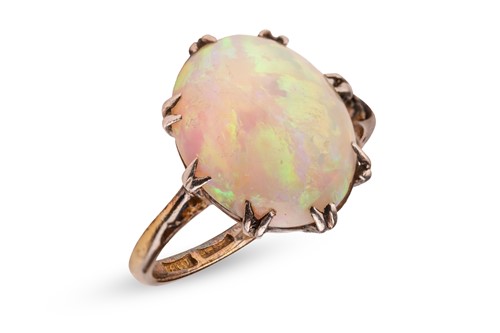 Lot 33 - An opal dress ring, claw-set with a precious...