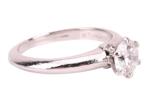 Lot 293 - Tiffany & Co. - a diamond solitaire ring in...