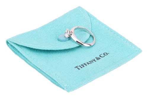 Lot 293 - Tiffany & Co. - a diamond solitaire ring in...
