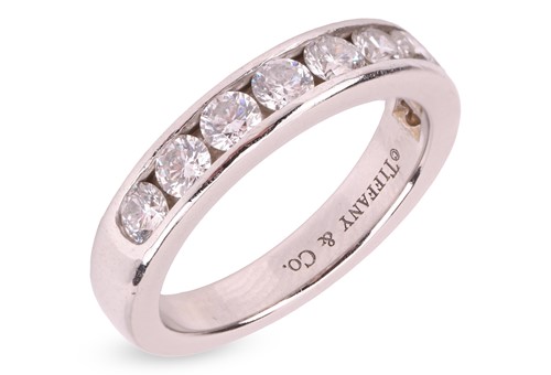 Lot 54 - Tiffany & Co. - a diamond half-eternity ring,...