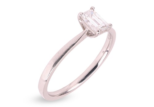 Lot 254 - An emerald-cut diamond solitaire ring in...