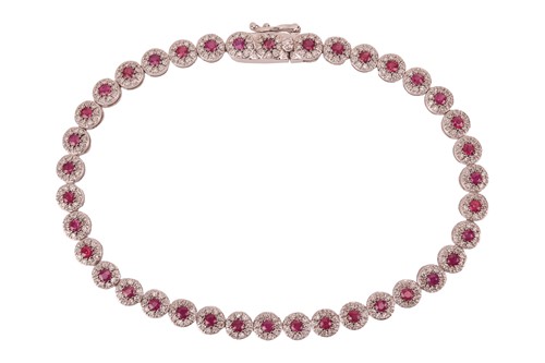 Lot 297 - A ruby and diamond cluster bracelet, composed...