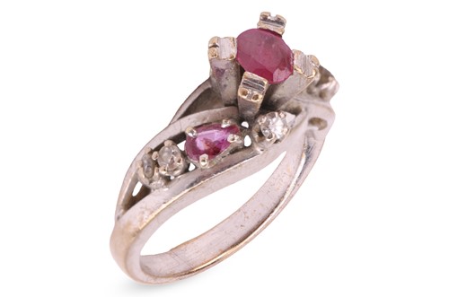 Lot 79 - A ruby and diamond crossover ring, centred...