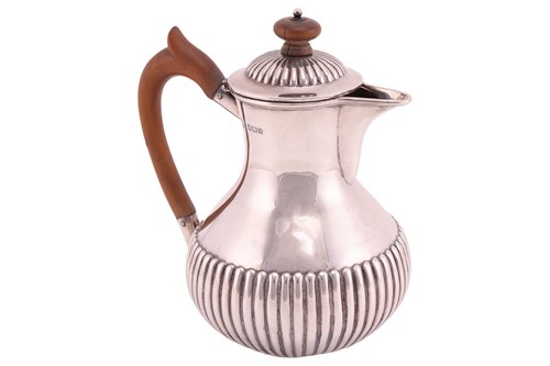 Lot 447 - A late Victorian silver hot water jug, the...