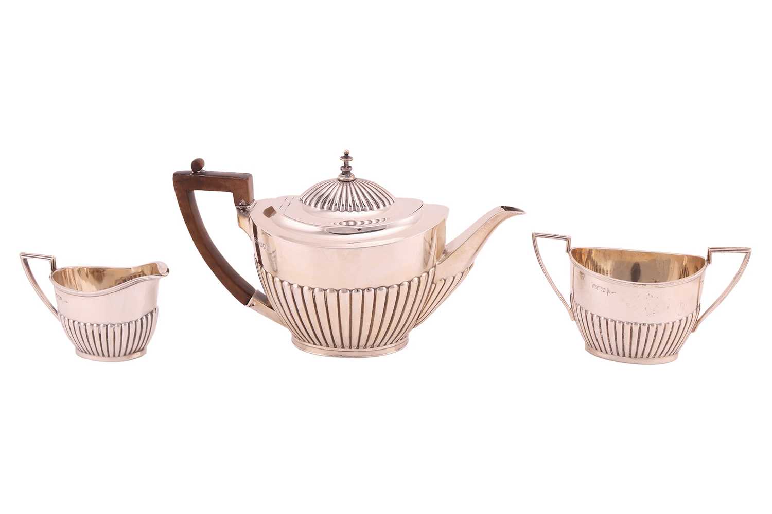 Lot 474 - A three-piece silver tea set of boat form