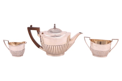 Lot 474 - A three-piece silver tea set of boat form with...