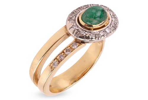 Lot 67 - An emerald and diamond halo ring; collet-set...