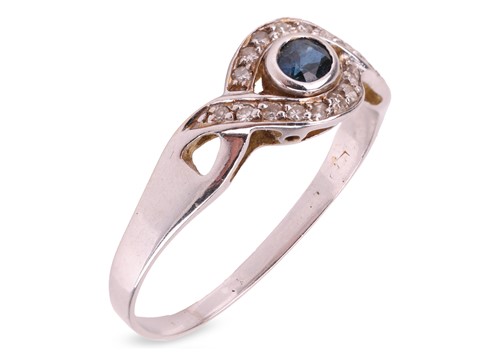 Lot 103 - A sapphire and diamond dress ring; centred...