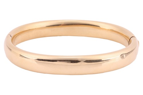 Lot 36 - A hinged bangle; the court-shaped hollow...