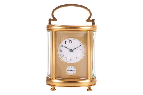 Lot 103 - An oval cased carriage alarm clock, with a...