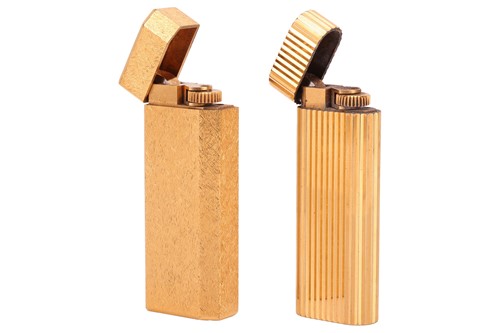 Lot 145 - Cartier - two gold-plated lighters, one of...