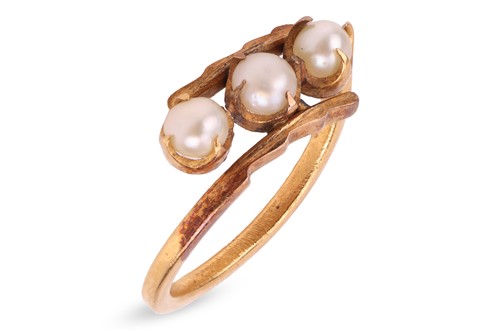 Lot A cultured pearl crossover ring, claw-set with...