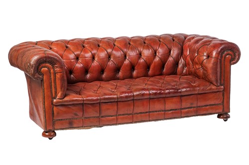 Lot A deep-buttoned three-seat leather...