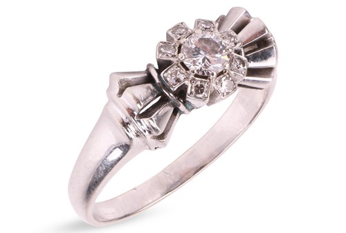 Lot A diamond cluster ring, centred with a round...