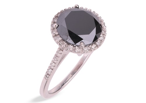 Lot A black diamond halo ring, centred with a...