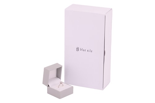 Lot An emerald-cut diamond solitaire ring in 14ct...