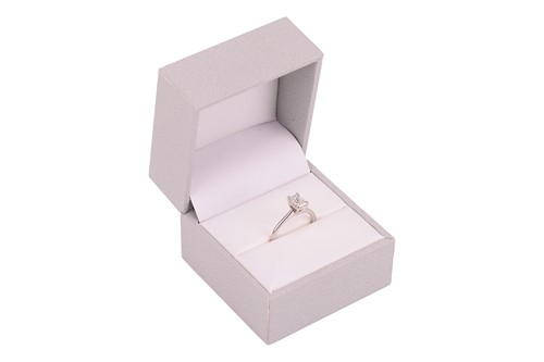 Lot An emerald-cut diamond solitaire ring in 14ct...