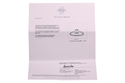 Lot An emerald-cut diamond solitaire ring in 14ct...