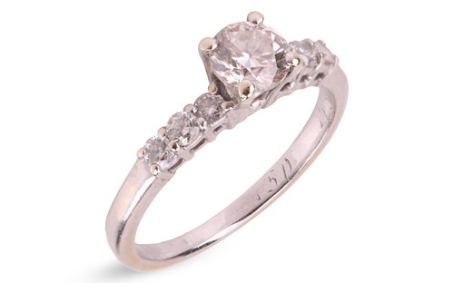Lot A diamond solitaire ring, with an estimated...