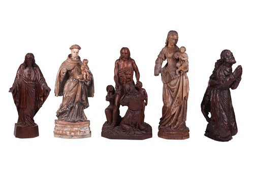 Lot A group of religious carvings including an...
