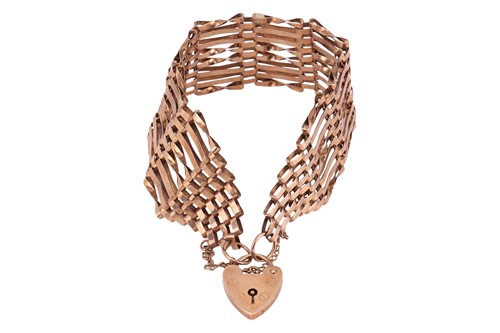 Lot A wide gate link bracelet in 9ct gold, the...